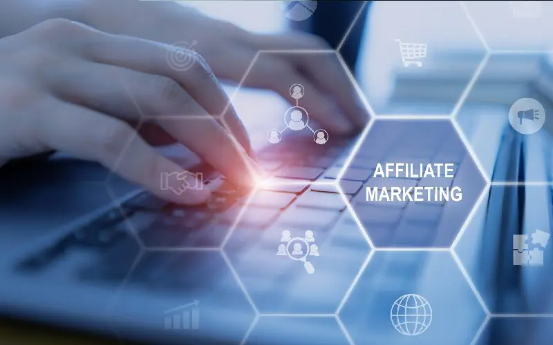 Hands typing on laptop, affiliate marketing concept.