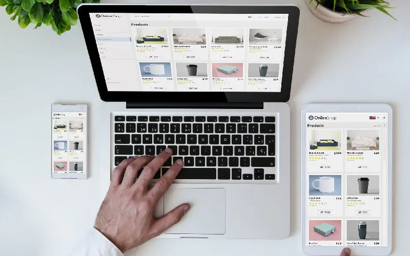 Person shopping online using multiple devices.
